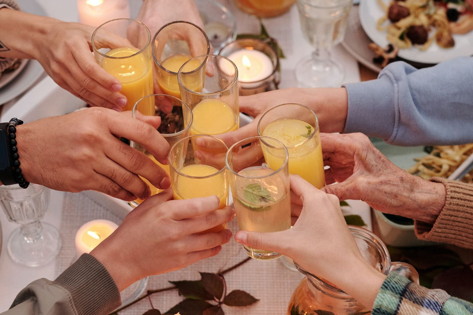 Group of hands toasting with drinks
